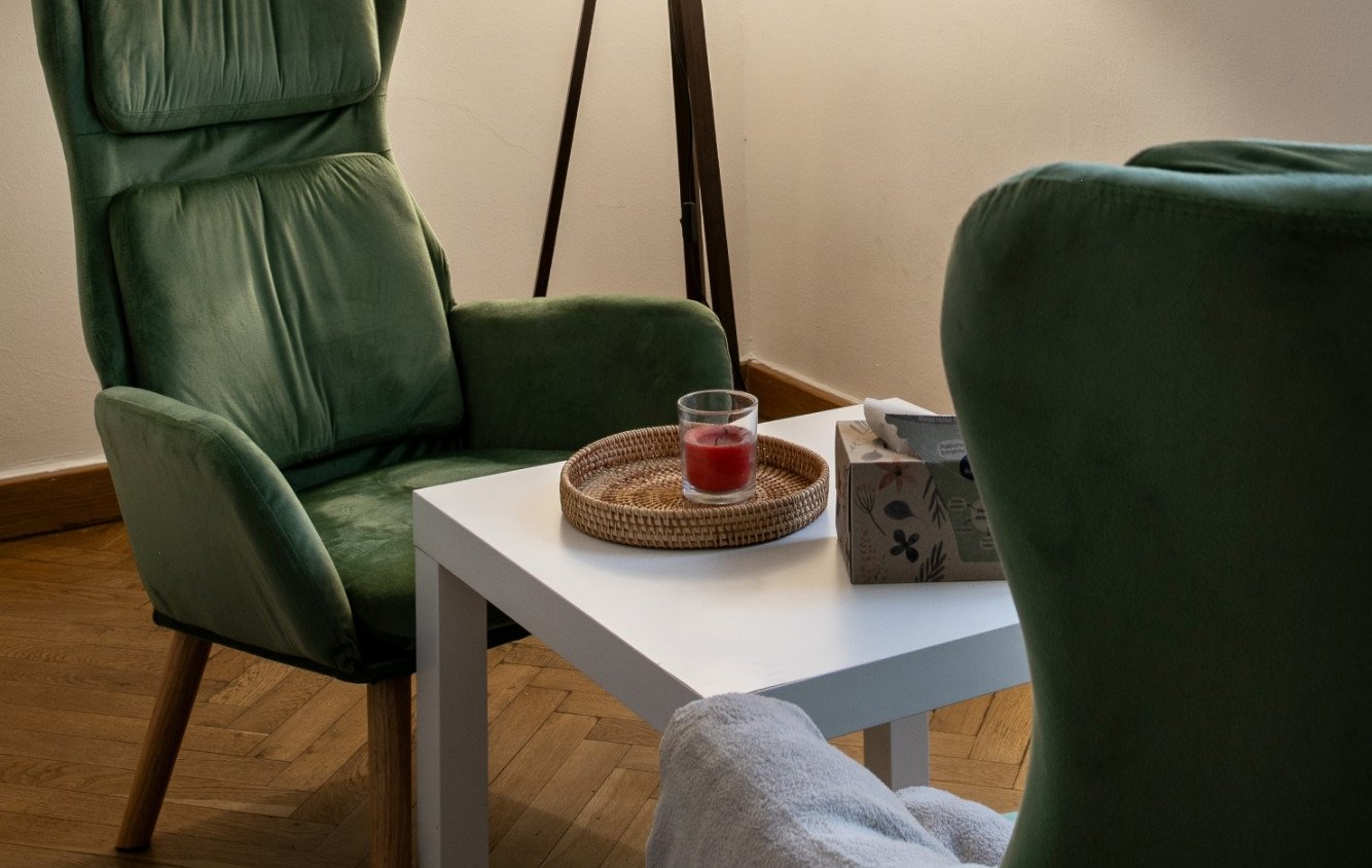Individual counselling room with green armchairs