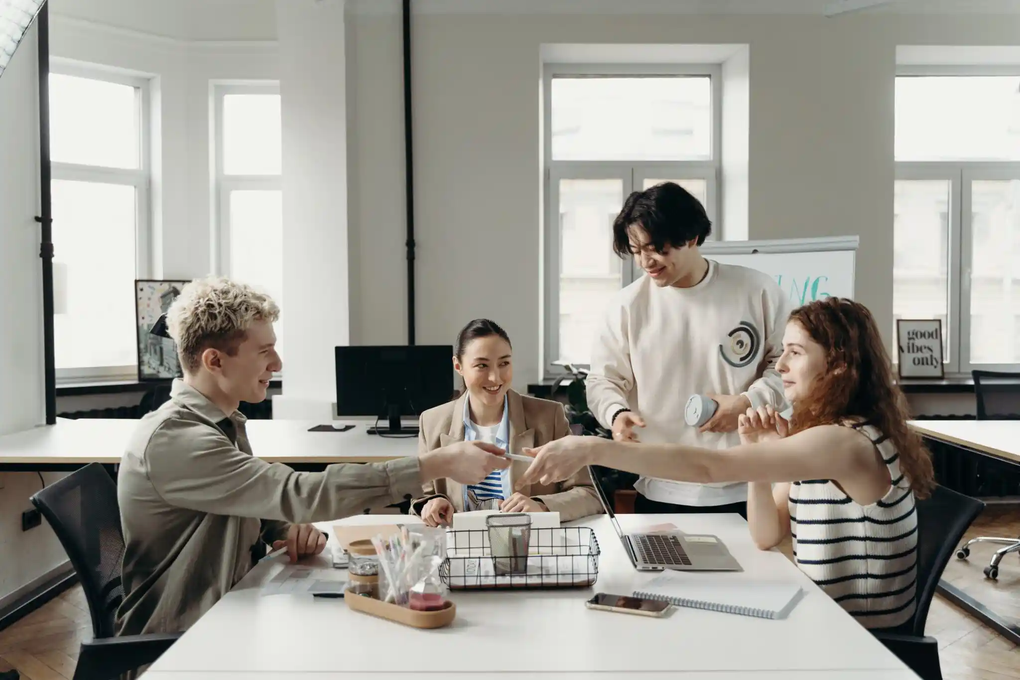 four people in office meeting