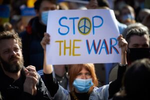 people with sign saying stop the war