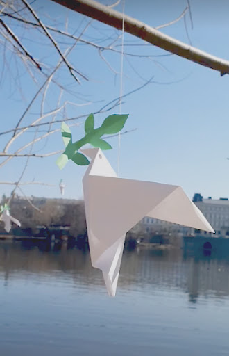 paper dove hanging on a branch