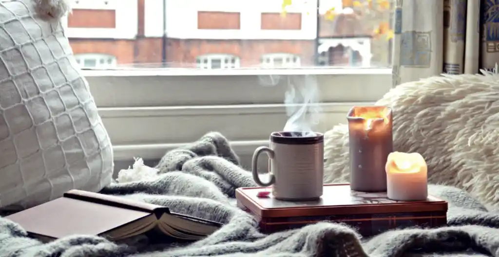 cosy home cup of coffee blanket and pillow