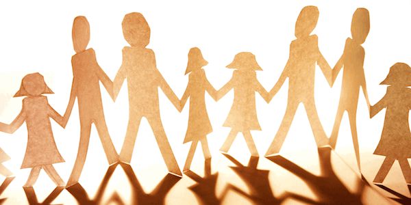 paper cutout of family holding hands