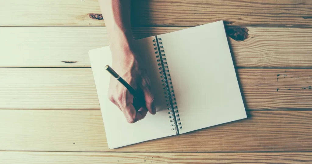 person writing in a journal
