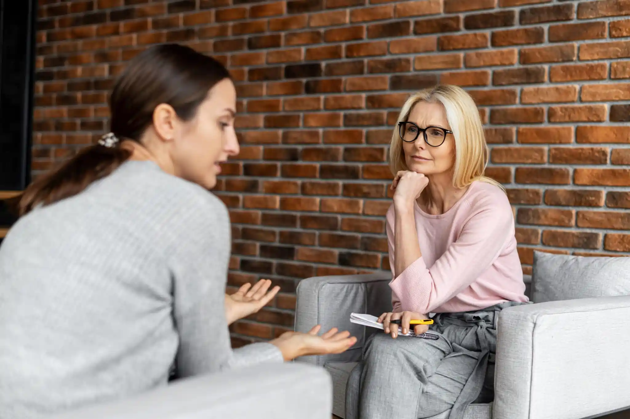 two women sitting opposite each other having a conversation