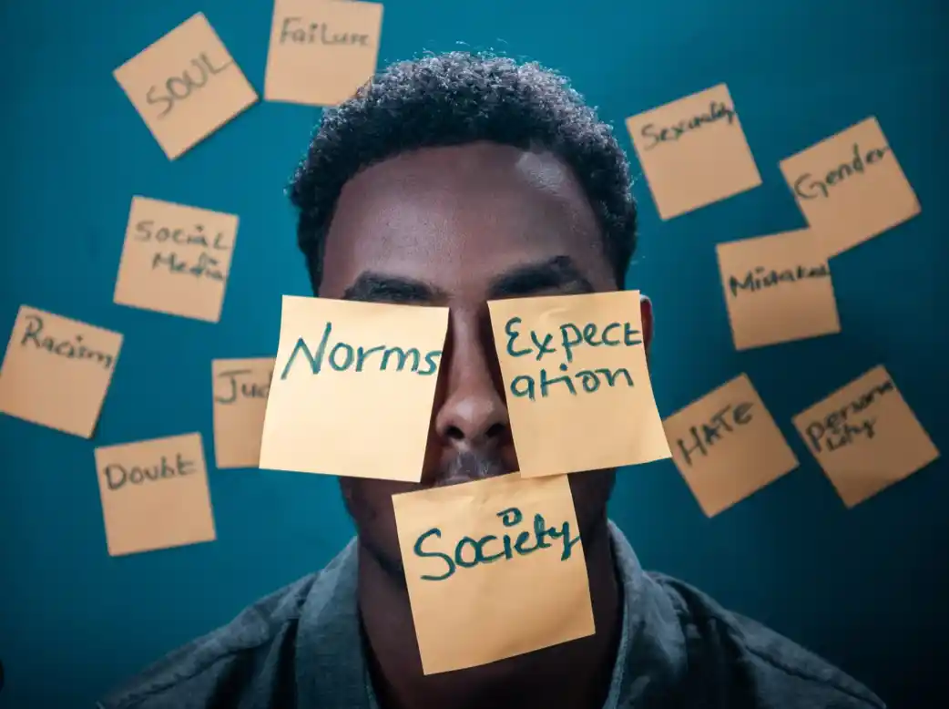 Multiple post it notes over mans face